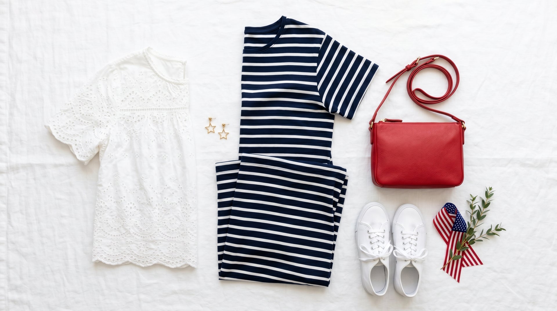 Patriotic outfit flat-lay with navy dress and red accessories