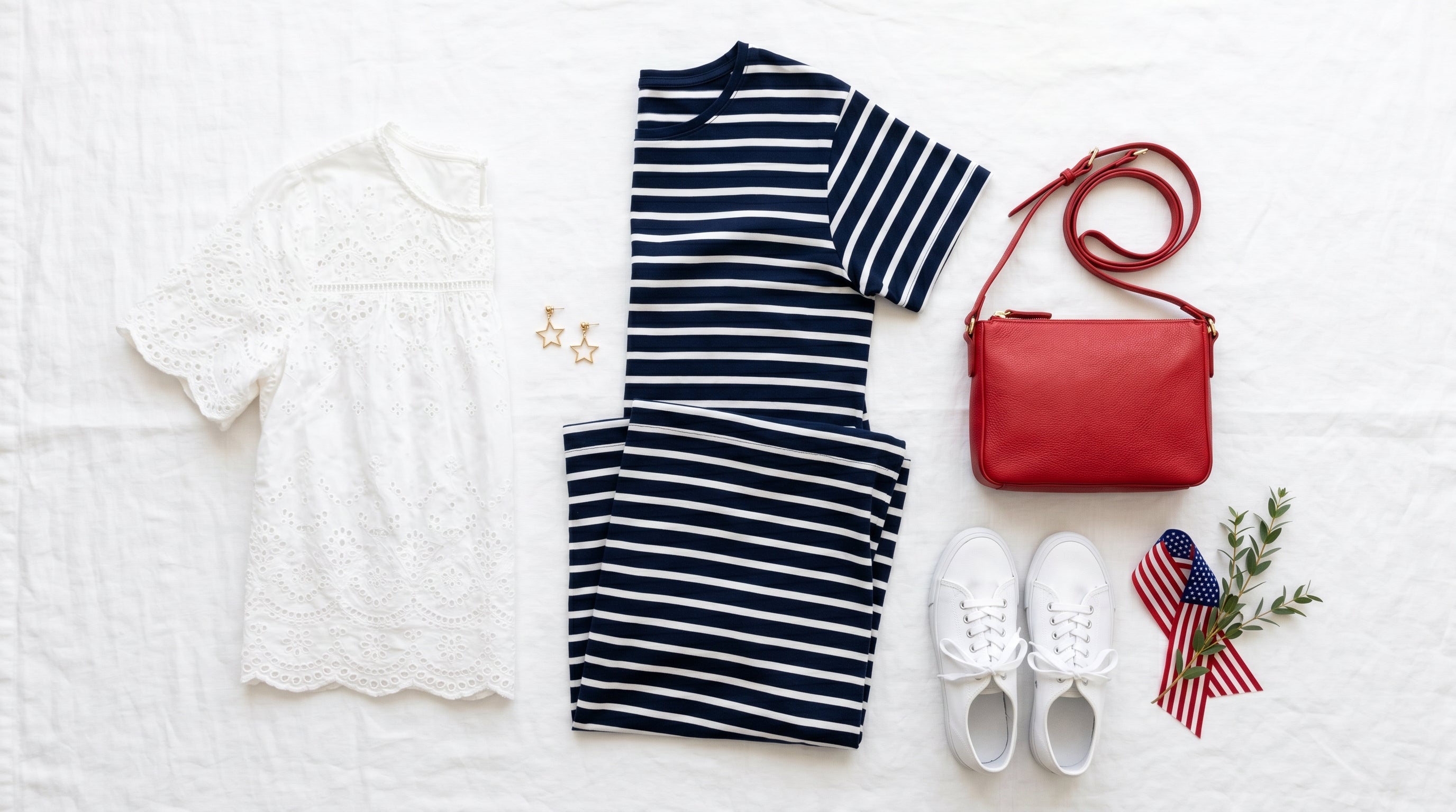 Patriotic outfit flat-lay with navy dress and red accessories