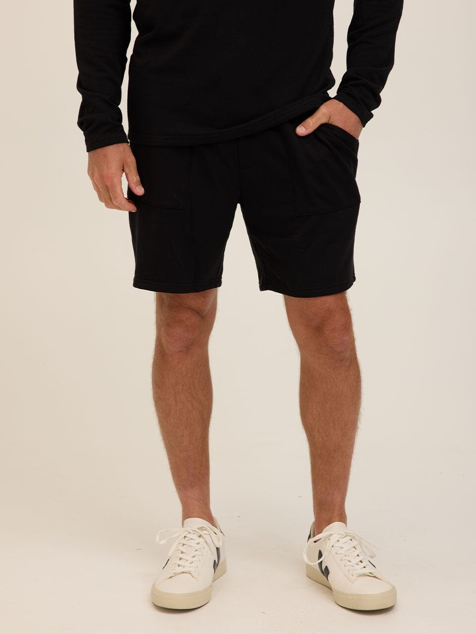 Men's solid black relaxed fit feather fleece shorts in a minimalist sporty style.