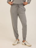 Women wearing heathered grey Core Feather Fleece Joggers with tapered fit and ribbed cuffs