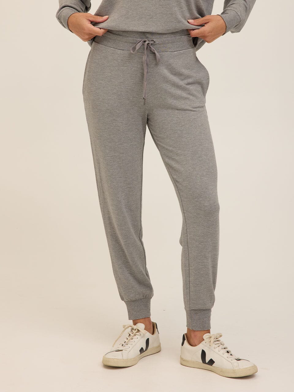 Women wearing heathered grey Core Feather Fleece Joggers with tapered fit and ribbed cuffs