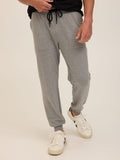 Man wearing comfortable Core Feather Fleece joggers in a relaxed casual setting