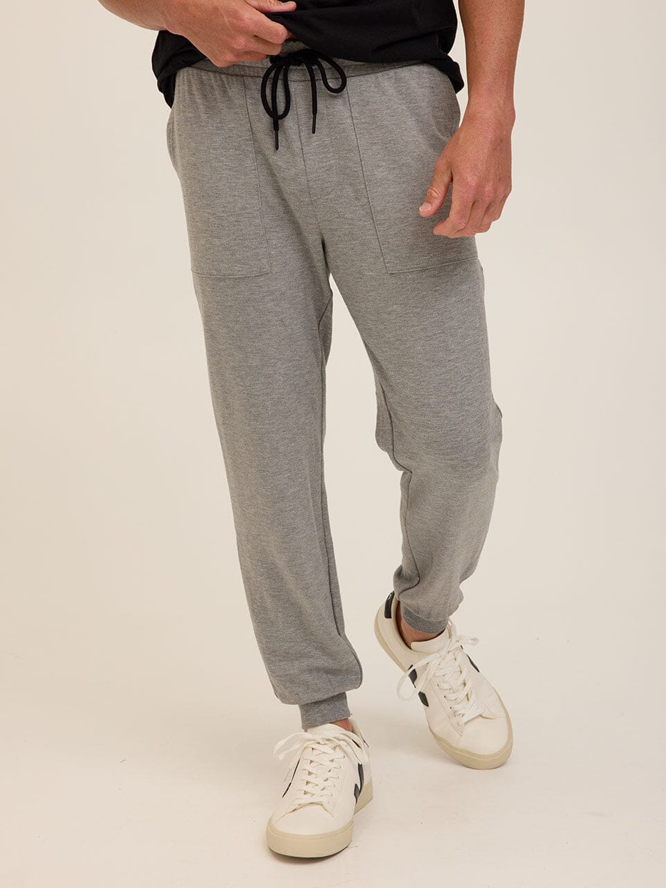 Man wearing comfortable Core Feather Fleece joggers in a relaxed casual setting