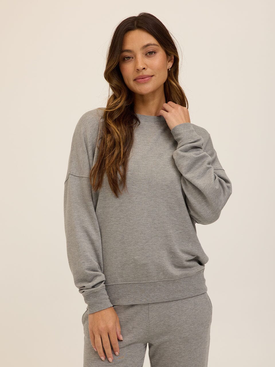 Close up of the Core Feather Fleece Sweatshirt in Grey showing the soft knit texture and relaxed fit.