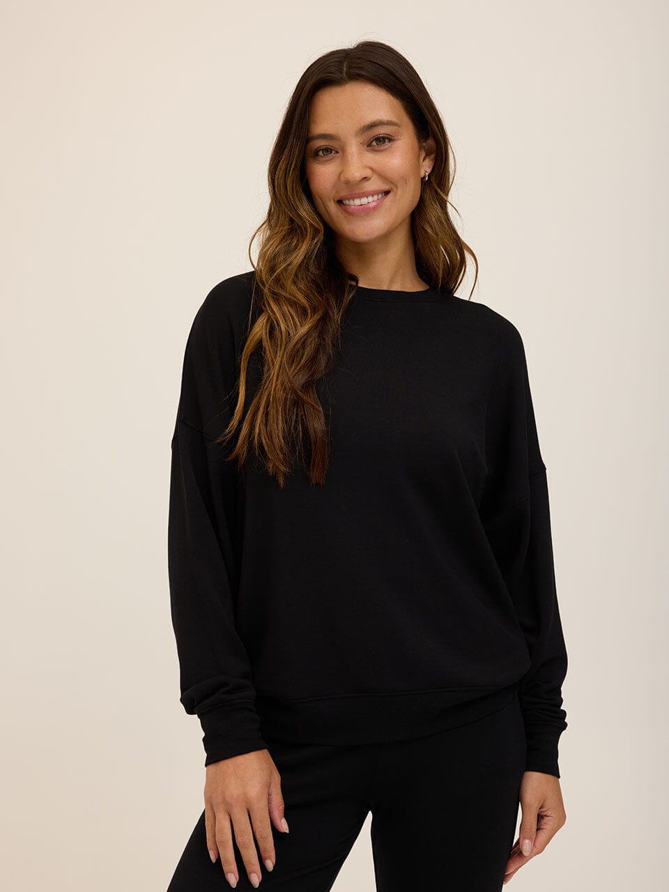 Front view of the Core Feather Fleece Sweatshirt in Black featuring a clean, minimalist design.