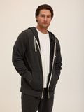 Men wearing a heathered charcoal zip-up triblend fleece hoodie with white drawstring details