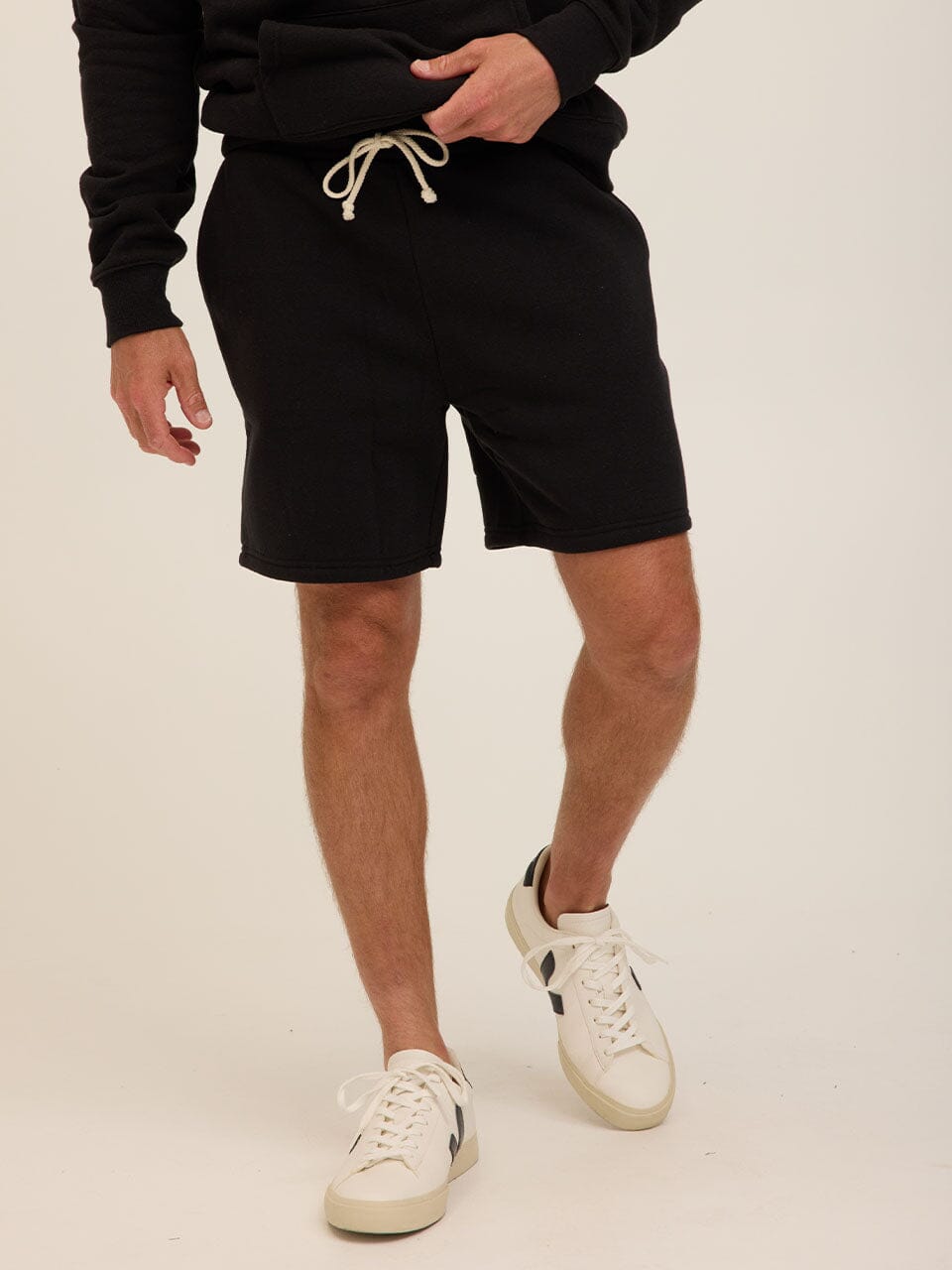 A pair of men's solid black triblend fleece shorts with an adjustable drawstring and relaxed silhouette.