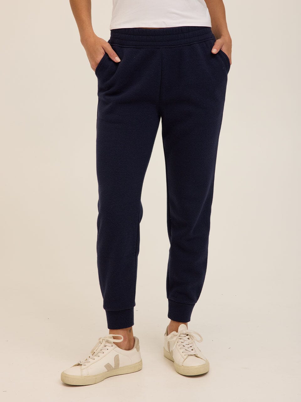 Woman wearing Rowena Triblend Fleece Joggers in navy blue with a relaxed fit and tapered ankle