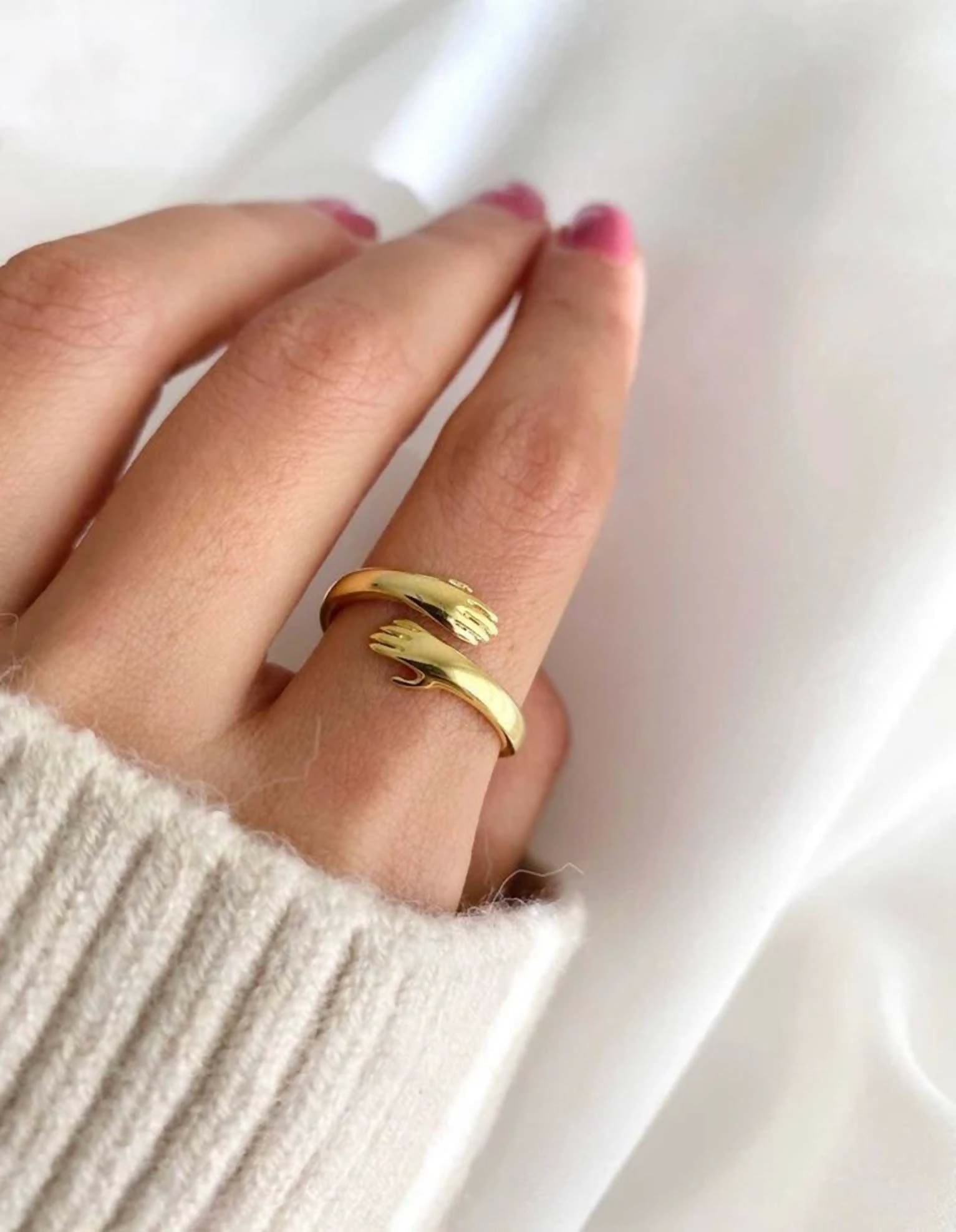 Polished golden brass adjustable ring with a modern, minimalist design on a neutral background.