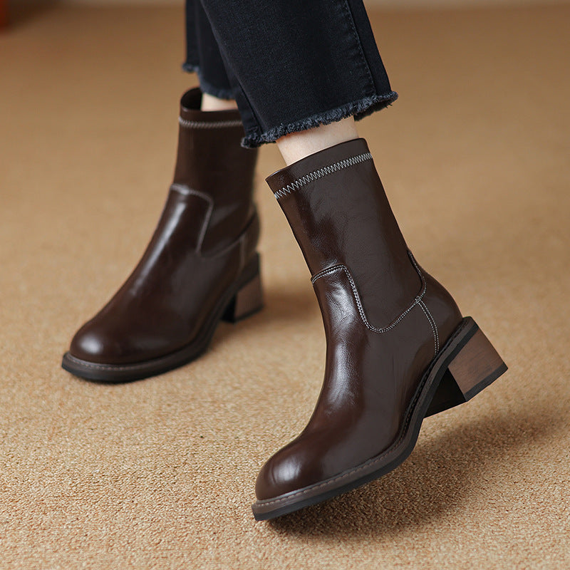 Women wearing stylish dark brown mid-heel Martin boots with a square heel and contrast stitching.