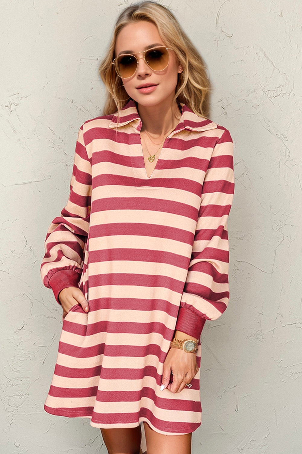 Woman wearing a striped long sleeve dress with a contrast white collar and structured fit.