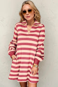 Woman wearing a striped long sleeve dress with a contrast white collar and structured fit.