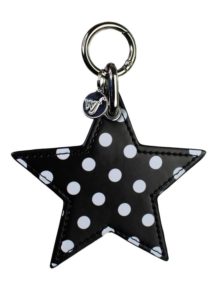 A black and white faux leather star-shaped charm with a metal clip and logo tag.