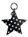 A black and white faux leather star-shaped charm with a metal clip and logo tag.