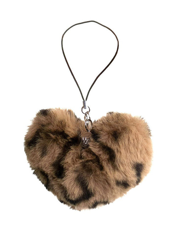 A fuzzy brown leopard print heart phone charm attached to a loop, shown both individually and attached to a floral phone case.