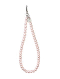 Close up of a pink pearl wristlet strap for mobile phones