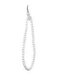 White pearl wristlet strap attached to a mobile phone case held in a hand