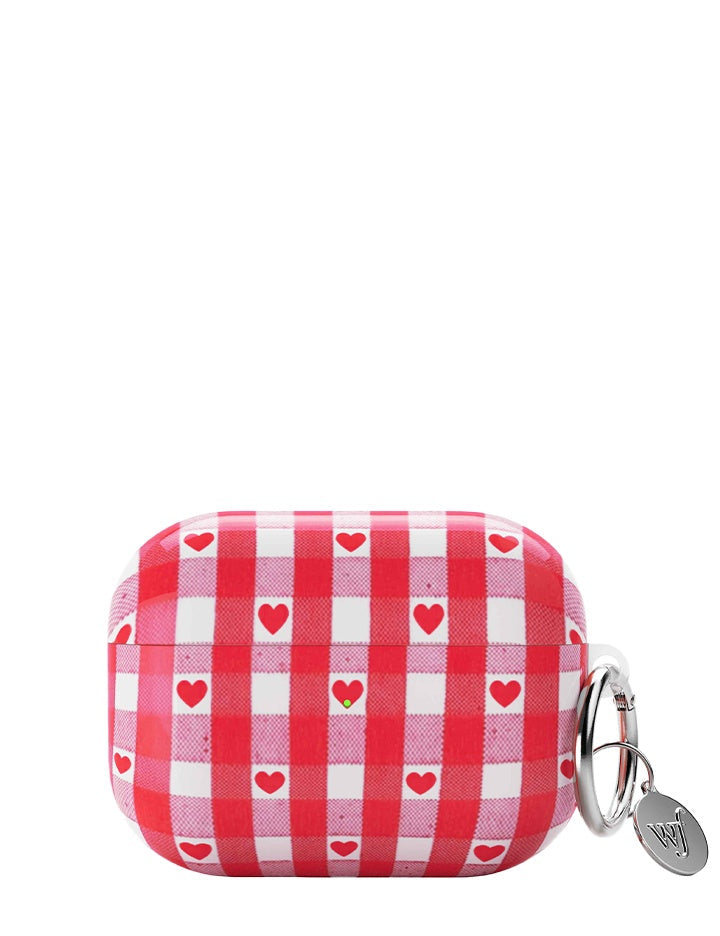Red and white gingham patterned AirPods case with red hearts and a silver keychain ring