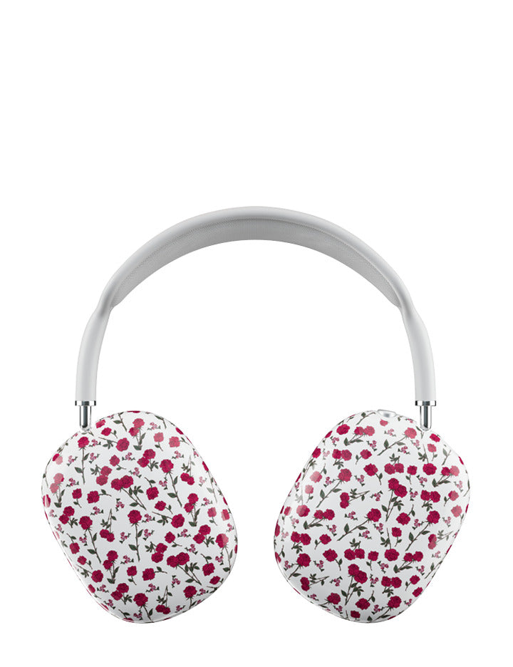 Close up of AirPods Max headphones wearing a white protective cover with a red rose floral pattern.