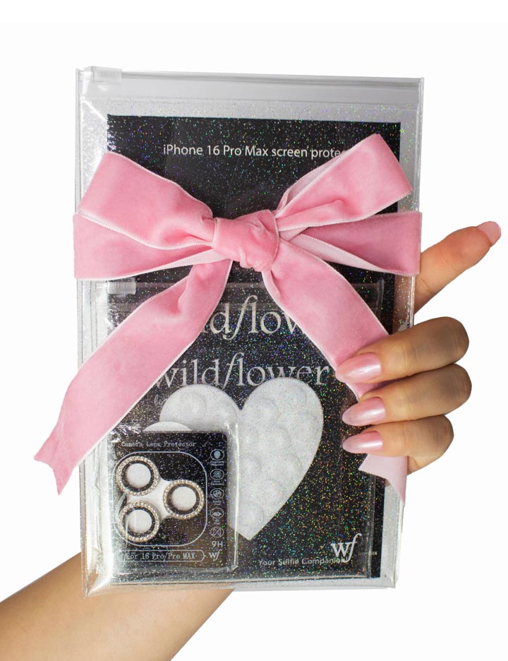 White phone accessory starter pack including a heart-shaped mount, screen protector, and silver camera bling in a clear pouch with a pink bow.