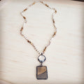 Long necklace featuring beige and brown Picture Jasper beads, clear crystal spacers, a faceted clear crystal accent, and a rectangular Jasper pendant in a dark metal setting.