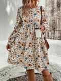 Bohemian style tiered floral long sleeve dress in a flowy silhouette.