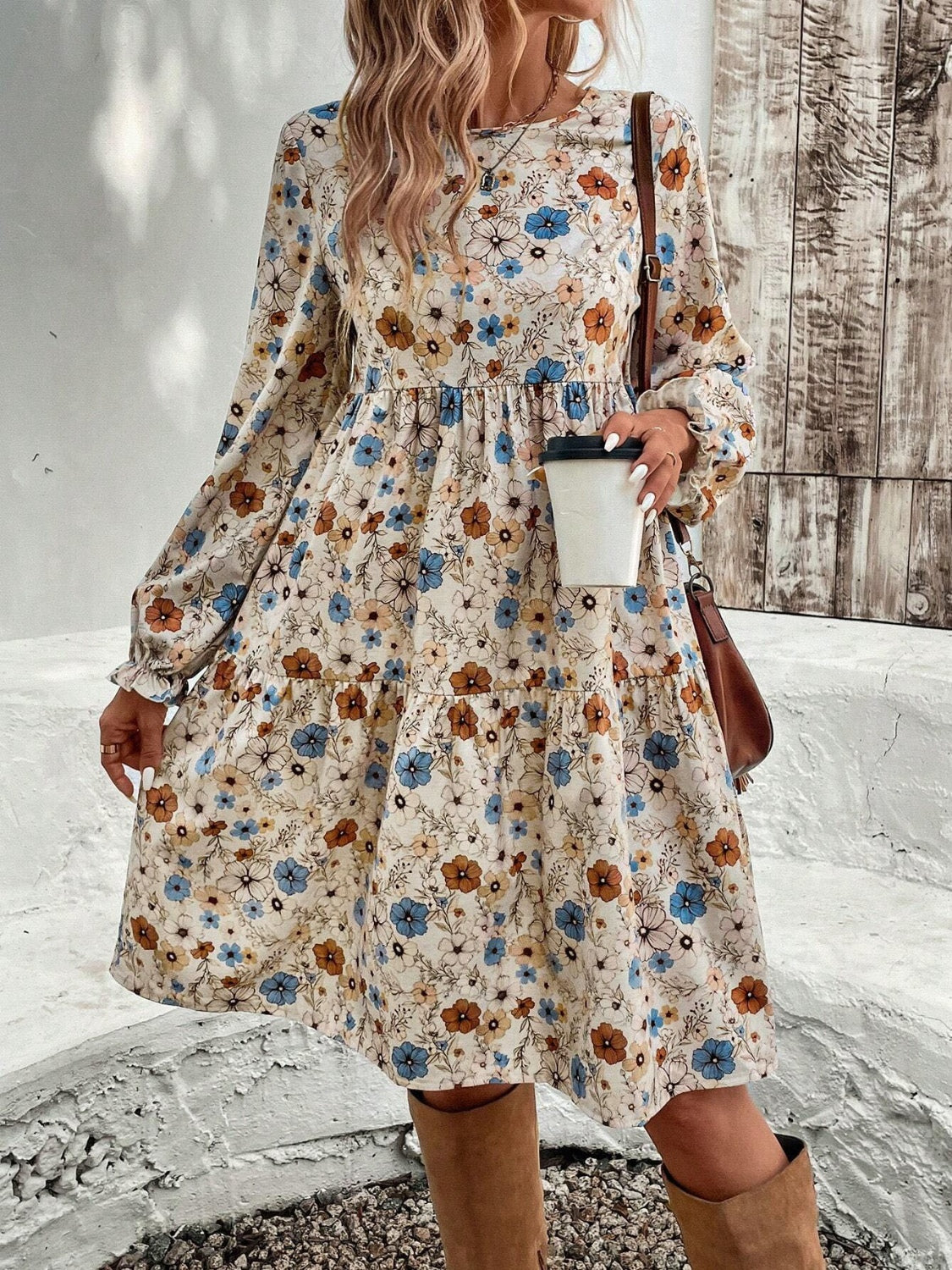 Bohemian style tiered floral long sleeve dress in a flowy silhouette.