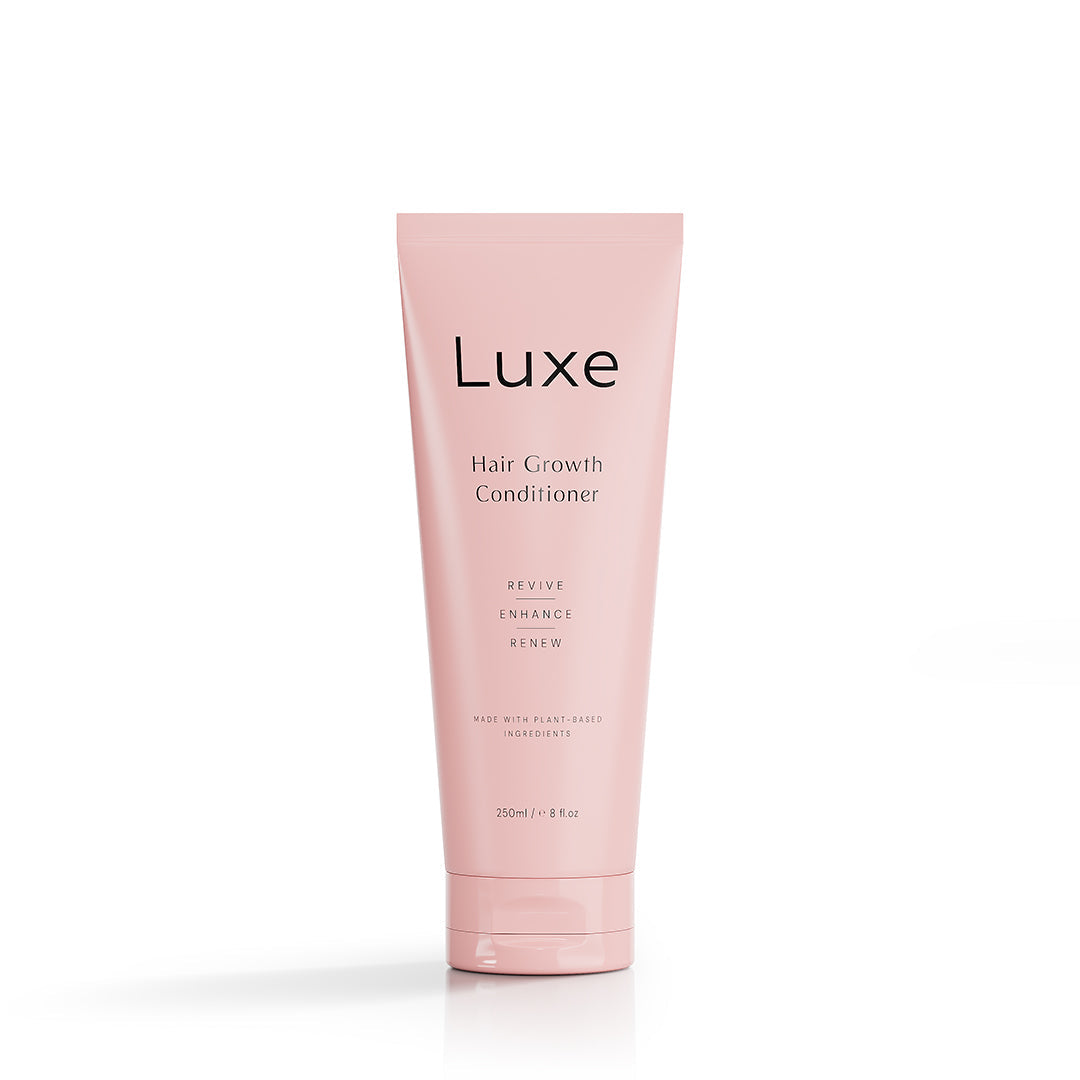 Pink bottle of Luxe Hair Growth Conditioner 250ml on a minimalist background