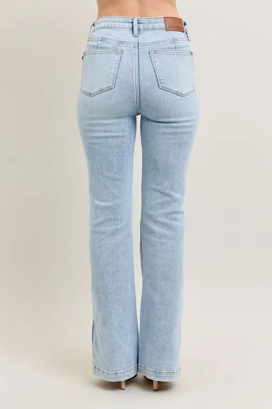 Light blue flared jeans on a plain background