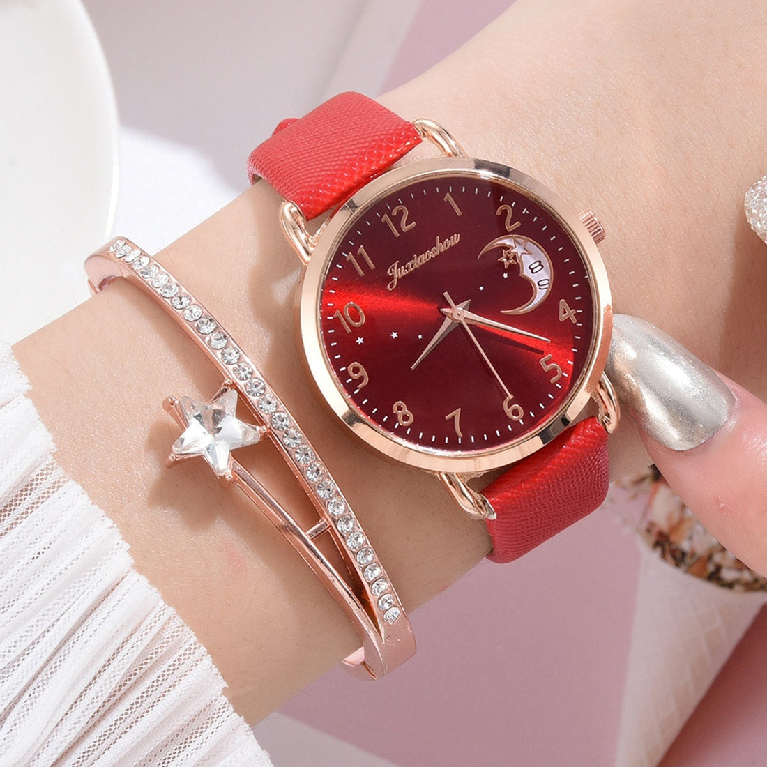 Women's Harajuku style watch with a leather strap and star and moon dial, shown with a rhinestone accent bracelet.