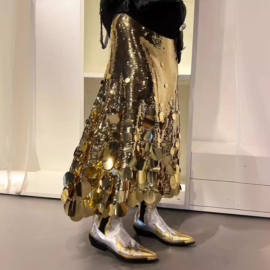 Woman wearing a glamorous gold A-line long skirt with sequin glitter detail