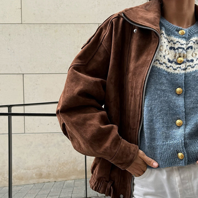 A woman wearing a beige suede-effect casual zip-up jacket over a sweater, featuring a collar and side pockets.