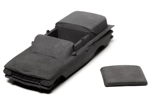 A monochromatic concrete incense burner inspired by a 1959 Chevrolet Brookwood, styled in a modern industrial living room.