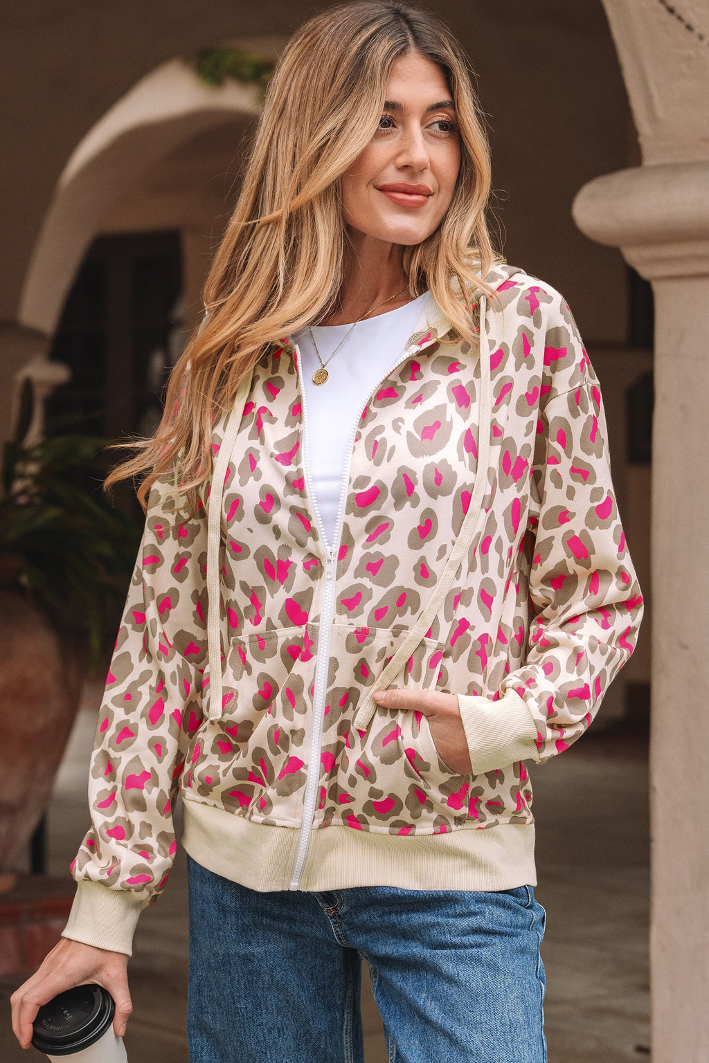 Model wearing a leopard print zip-up hoodie with hood up, showcasing the casual autumn style.