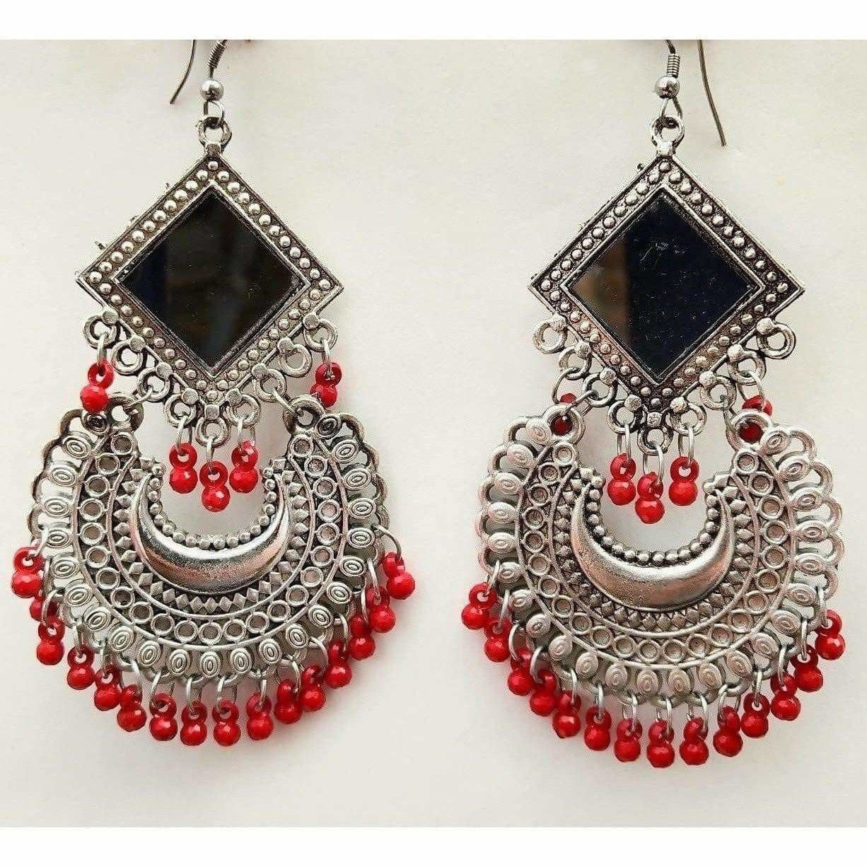 Silver tone Chandbali earrings featuring mirrors and red pearls