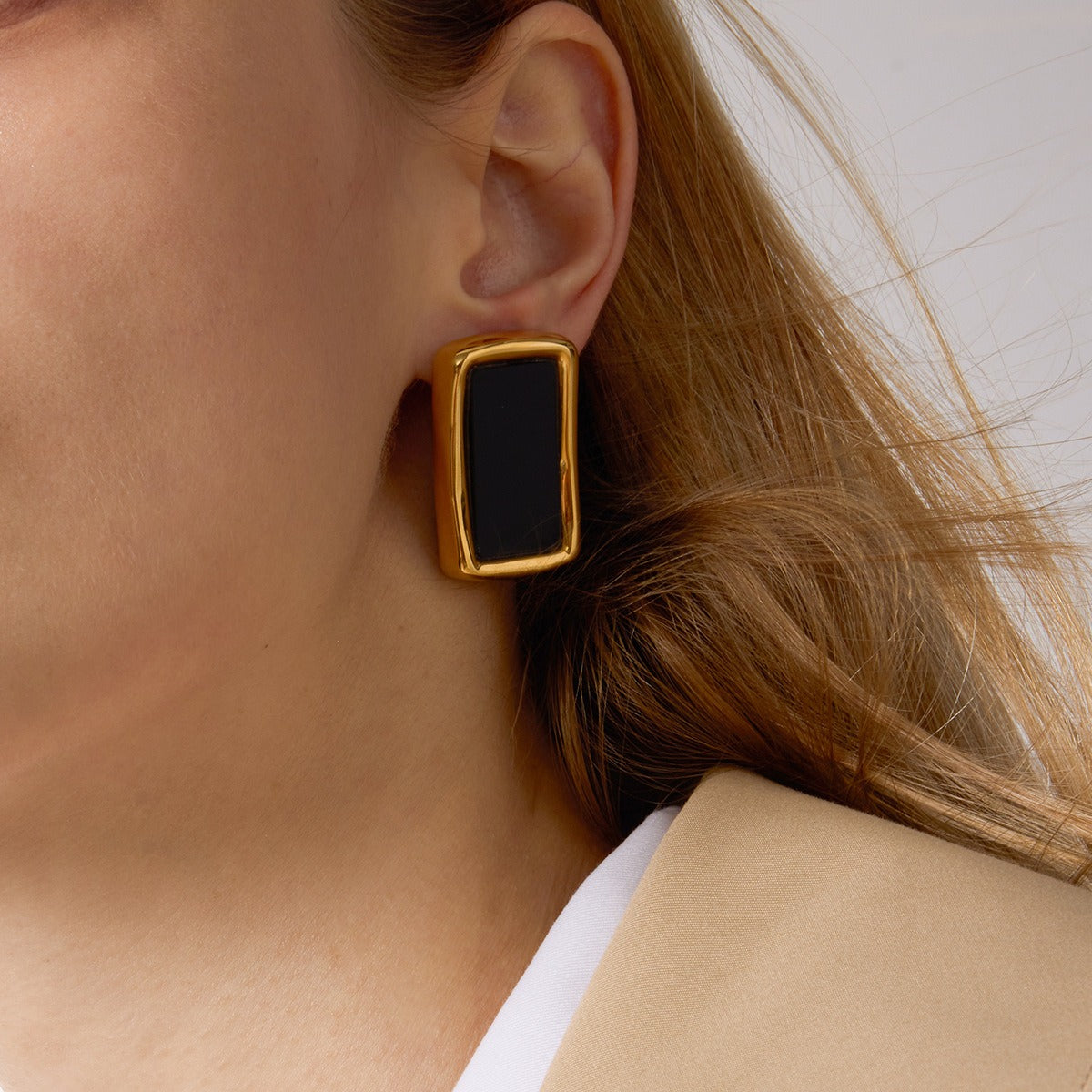 Modern 18K gold and black acrylic stud earrings in a minimalist geometric style.