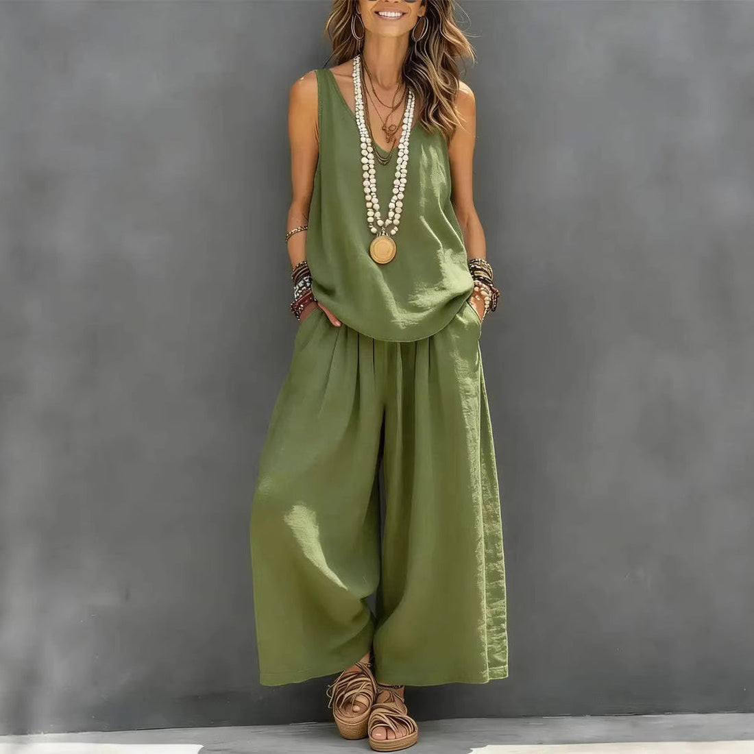 A woman wearing a two-piece set consisting of a sleeveless tank top and matching wide-leg pants in olive green and white color options.