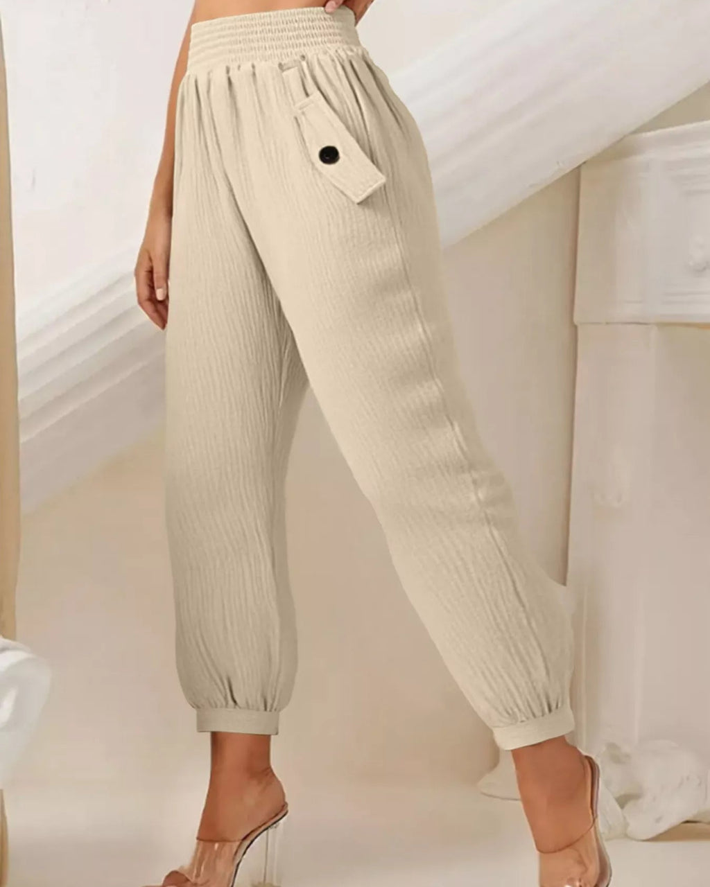 Beige pants worn by a person in a minimal indoor setting