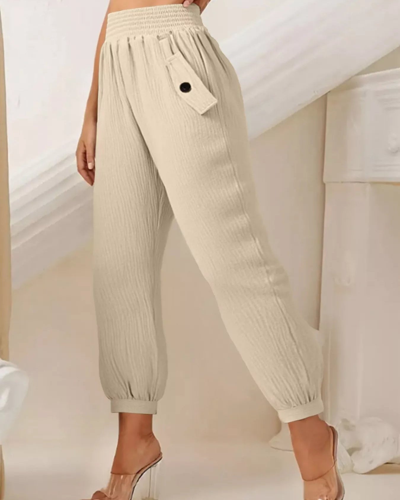 Beige pants worn by a person in a minimal indoor setting
