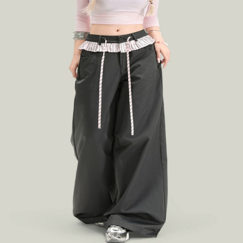 Model wearing black wide leg casual pants with vintage-inspired striped waist detailing and tie closure