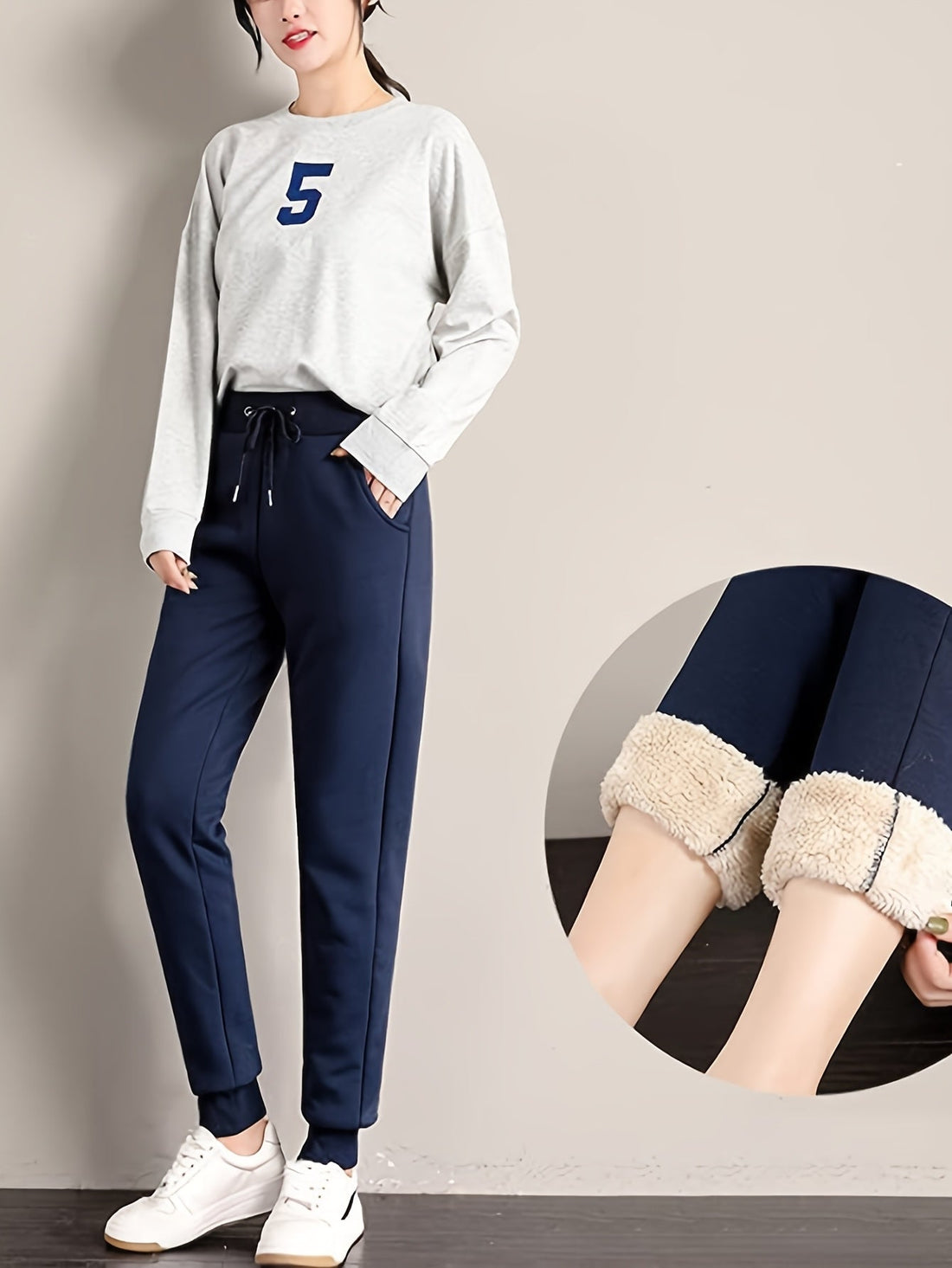 Model wearing dark blue fleece-lined boyfriend style joggers with white sneakers, plus a detail shot of the plush fleece interior.