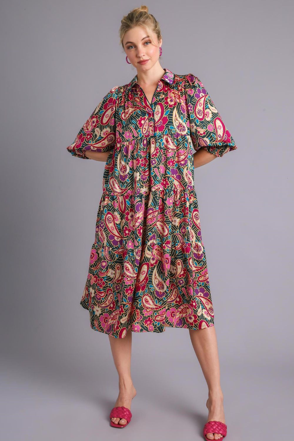 A beautiful printed satin midi dress with a tiered design in vibrant colors