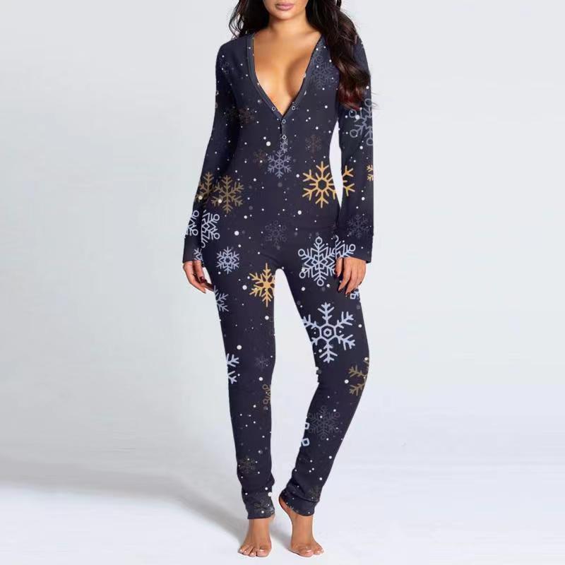 Woman wearing a festive V-neck printed knit button-front jumpsuit in a cozy home setting