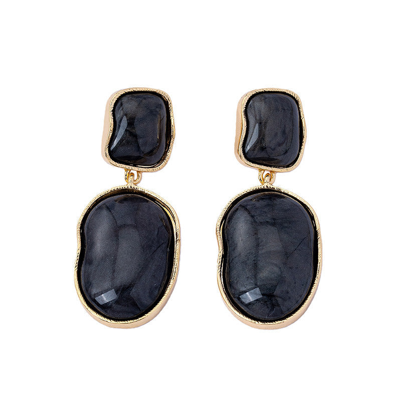 Minimalist double-layer geometric resin drop earrings in black, white, and gold colors.