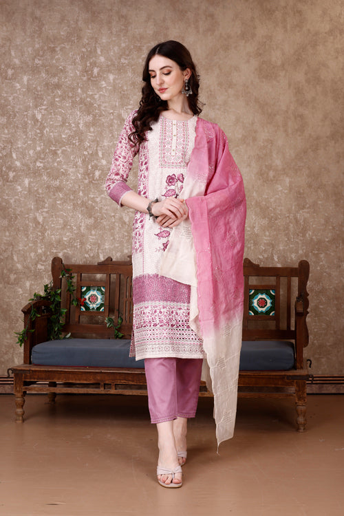 Woman wearing a multicolor floral printed hand-embroidered kurta set with matching pants and dupatta.