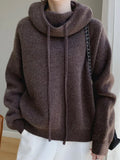 Woman wearing a thick mocha wool blend hooded sweater with long sleeves and ribbed cuffs