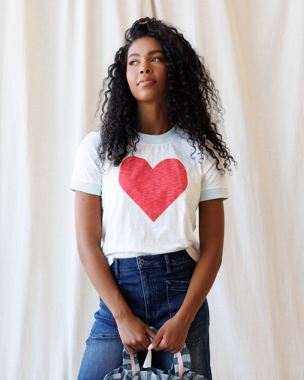 White women's ringer t-shirt with a heart graphic and red and light-blue trim.