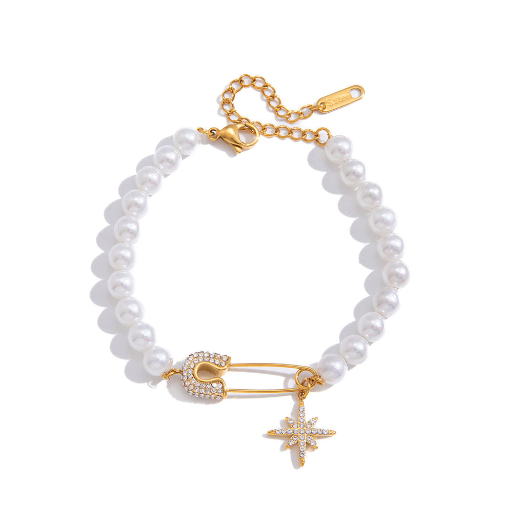 Gold stainless steel bracelet featuring faux pearls and zircon star charms on a white background.