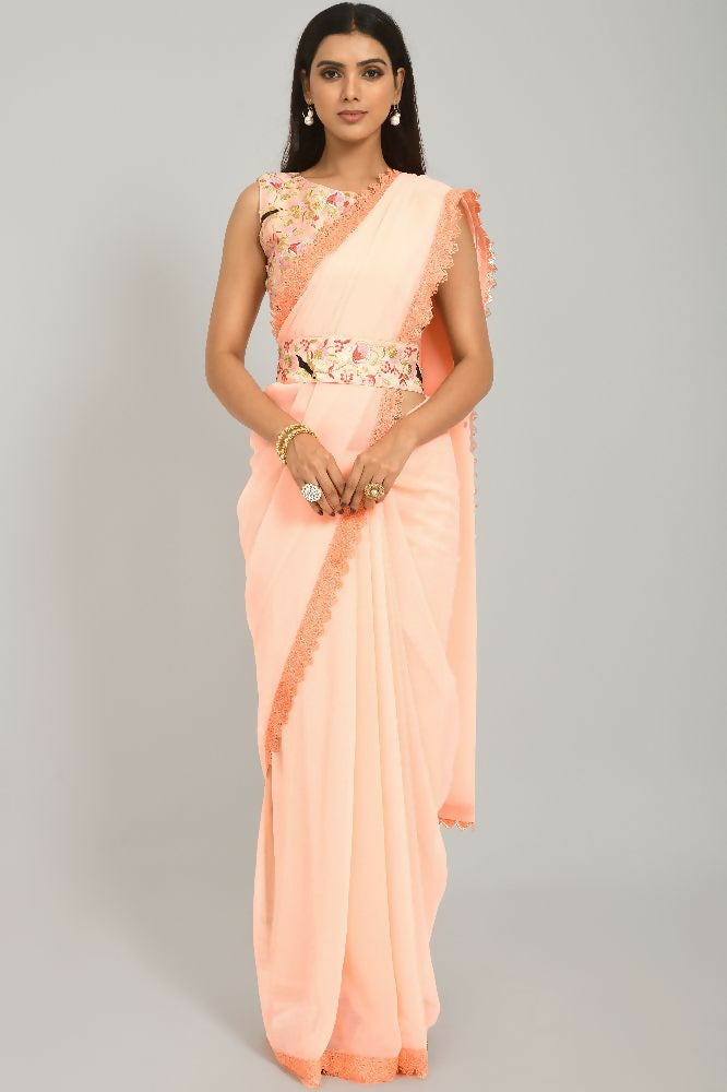 Soft peach Georgette saree featuring delicate GPO lace border and heavy Dhupiyan blouse