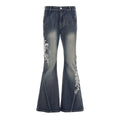 A pair of women's vibrant blue low waist flare jeans featuring intricate white floral embroidery on the legs.